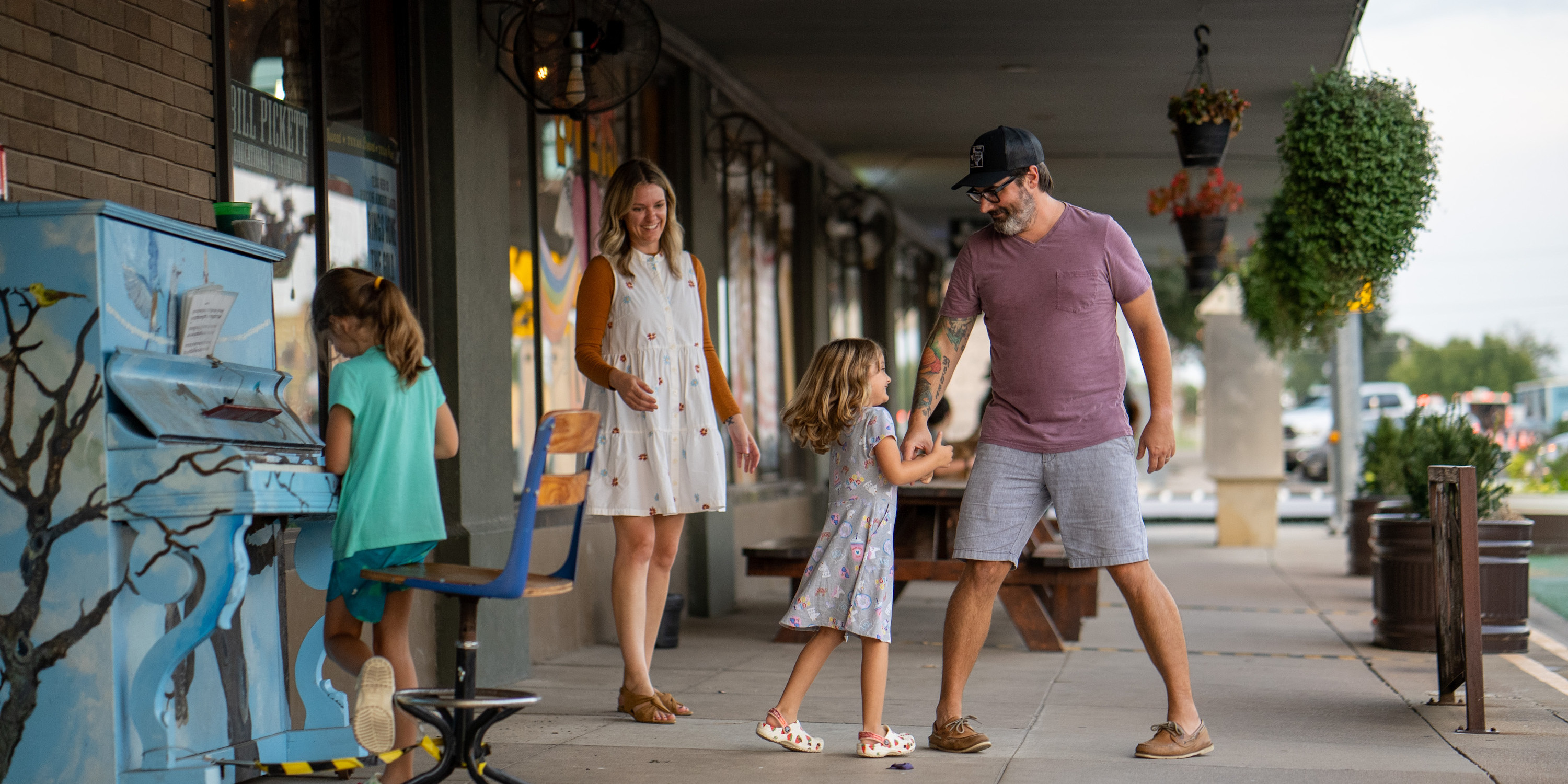 Father dancing with his daughter with his family on a business patio